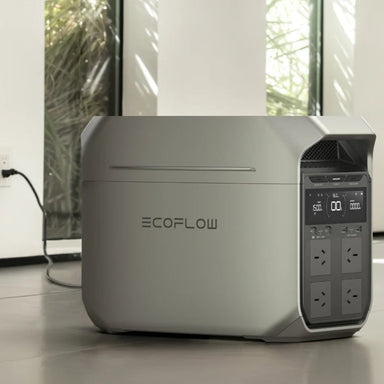A photo of an EcoFlow Delta 3 plus portable power station sitting on the floor of a house whilst plugged into an AC port.