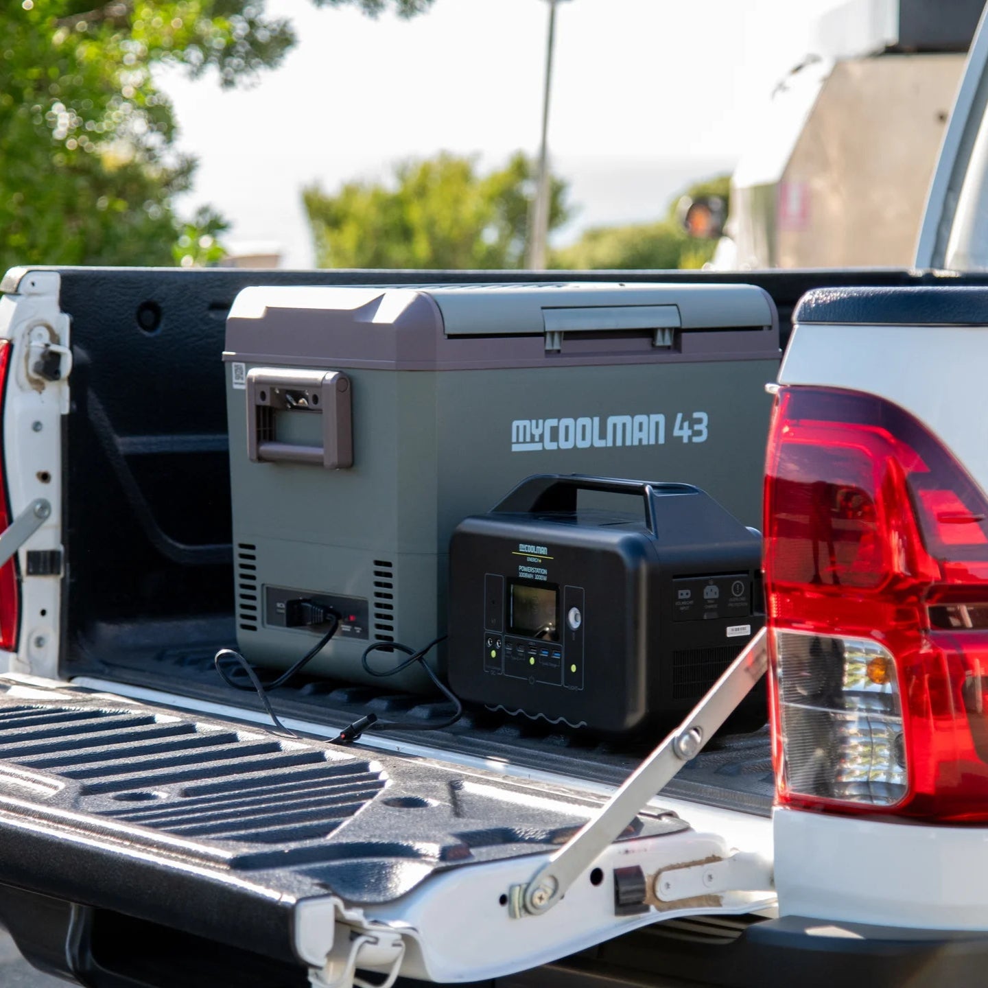 A photo of a MyCOOLMAN 1000W 78Ah Portable Power Station sitting in the tray of a ute.