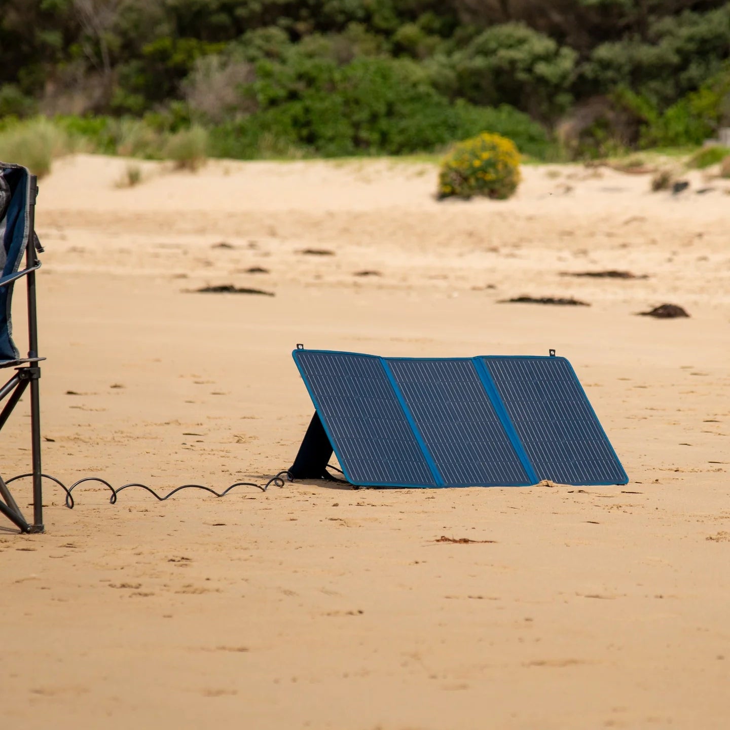 A photo of a MyCOOLMAN 100W Flexible Solar Blanket on sand.