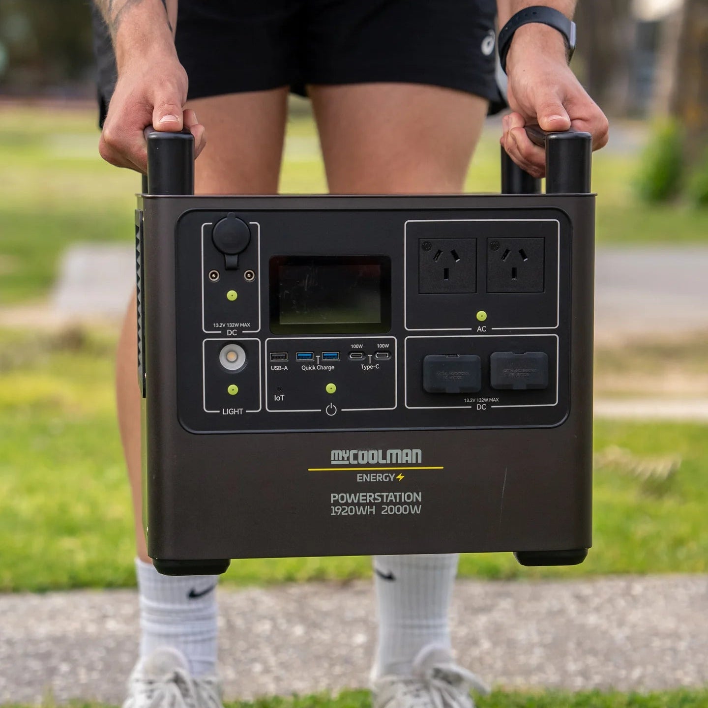 A photo of a mycoolman 2000W 150ah portable power station being carried outdoors.