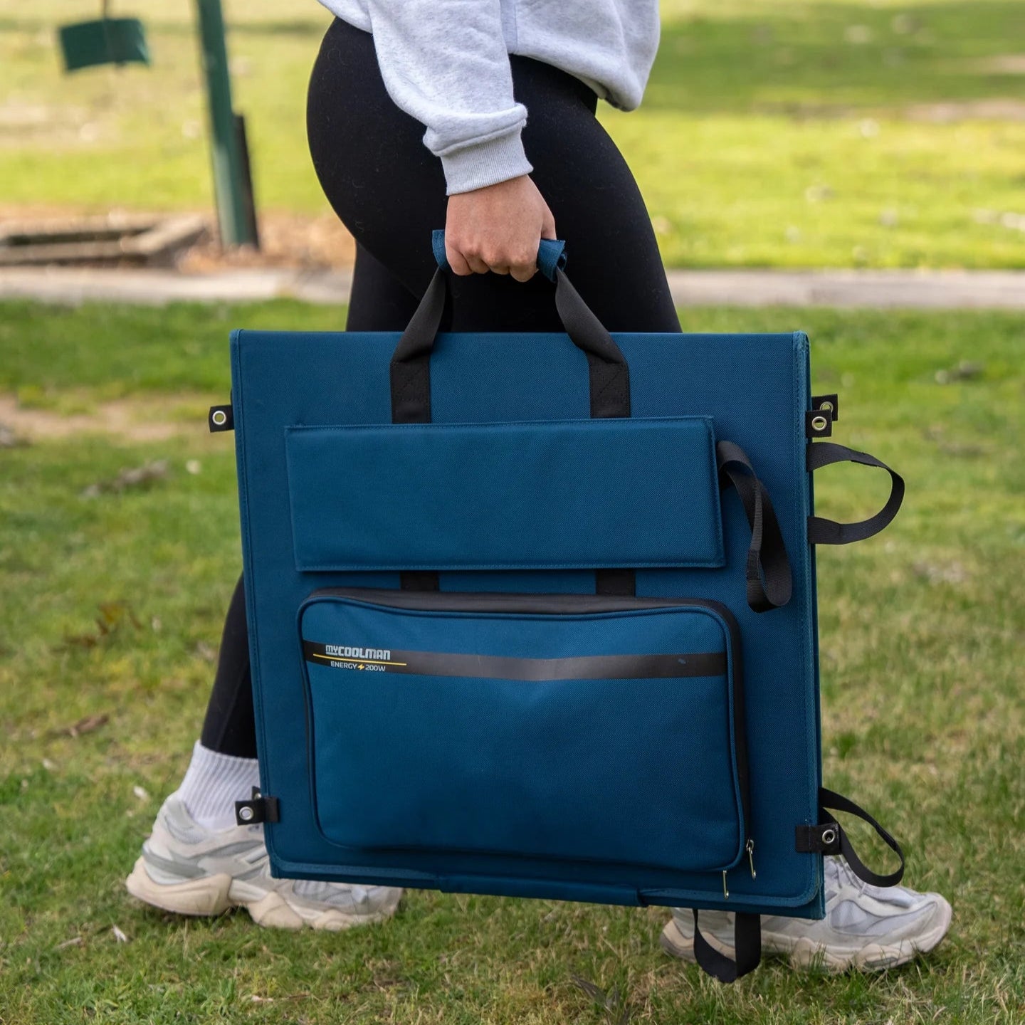 A photo of a MyCOOLMAN 200W Flexible Solar Blanket being carried