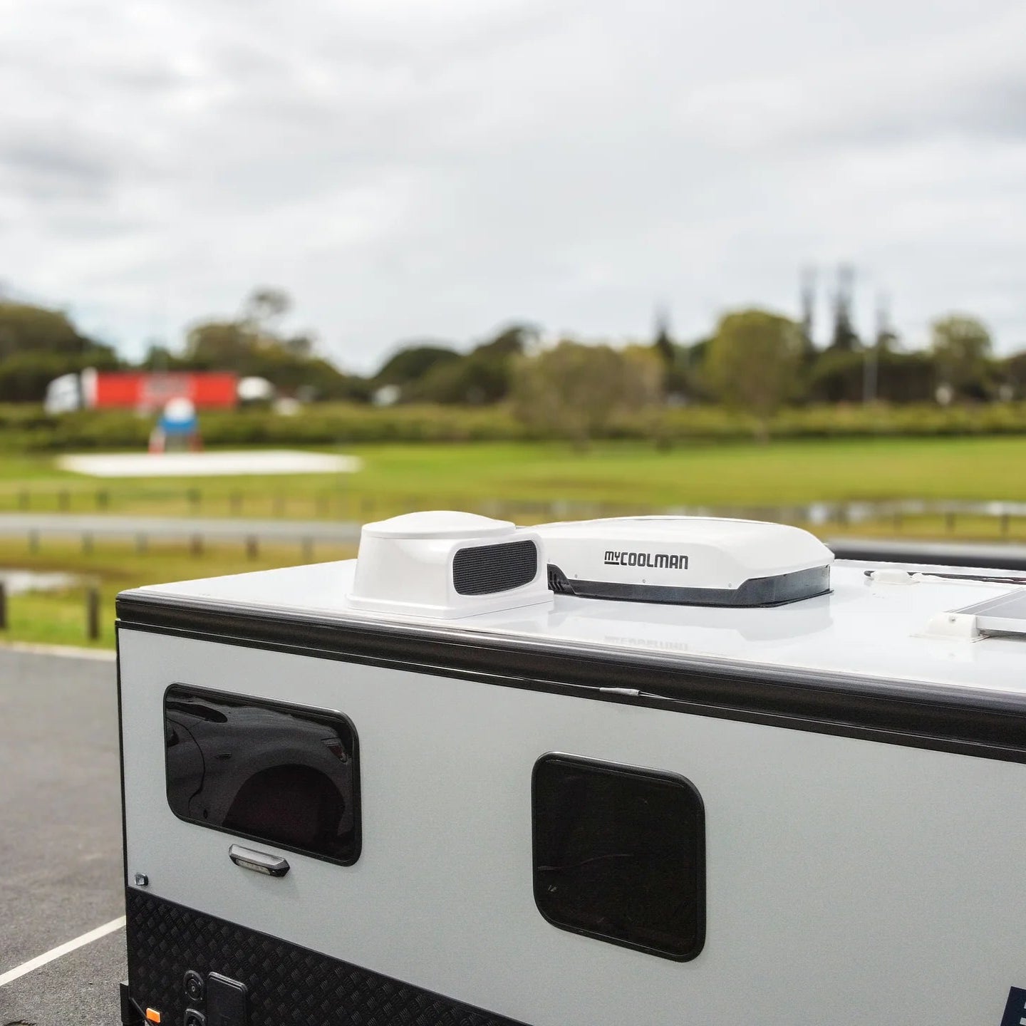 A photo of a white MyCoolMan 3KW Roof Top Air Conditioner on the roof of a caravan.