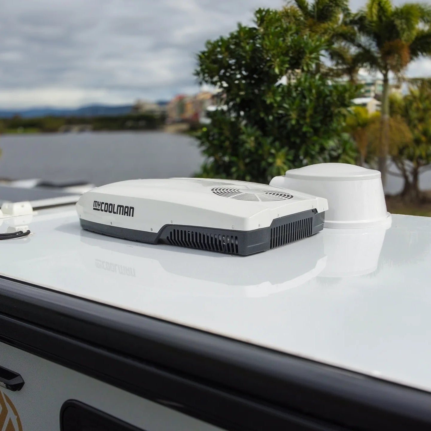 A photo of a white MyCoolMan 3KW Roof Top Air Conditioner on the roof of a caravan.