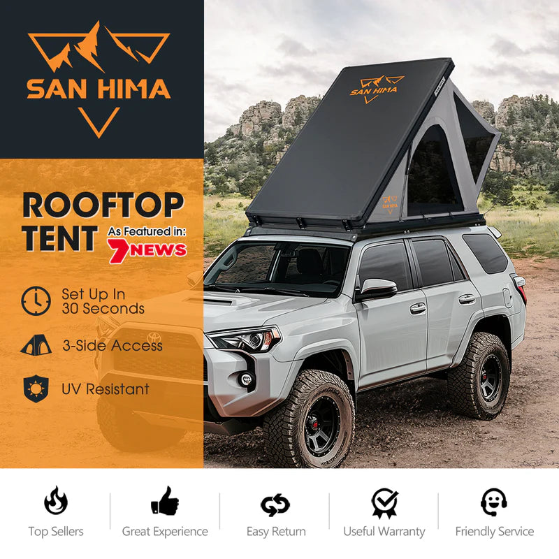 A photo of a San Hima lite hardshell roof top tent on top of a 4WD.