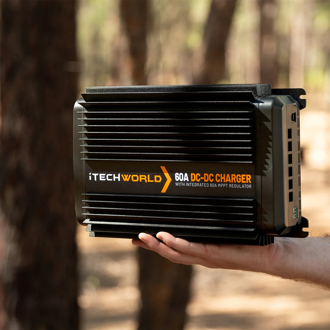 A photo of a mans hand holding an iTechWorld DCDC60 battery charger.