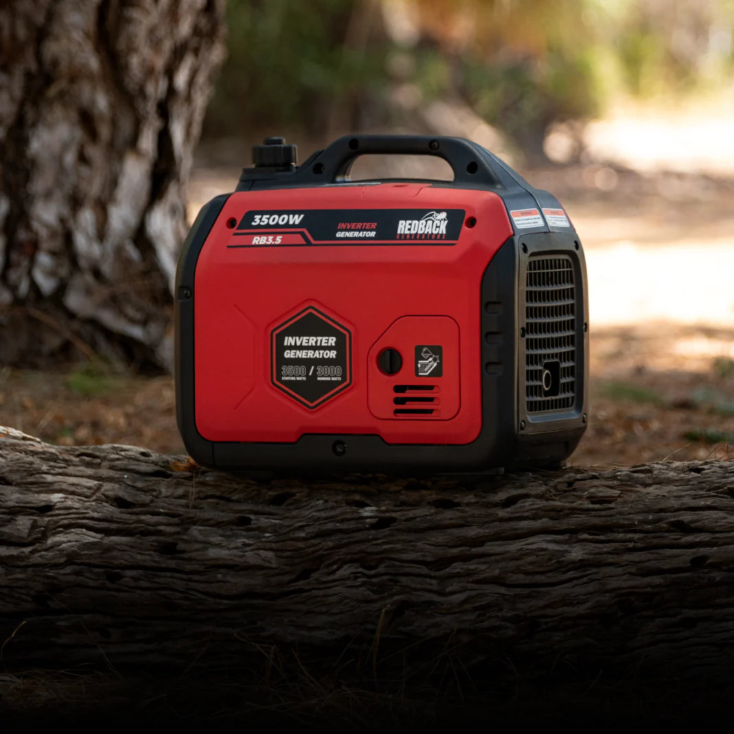 A photo of an iTechWorld Redback RB 3.5 3500W Portable Inverter Generator on a log.
