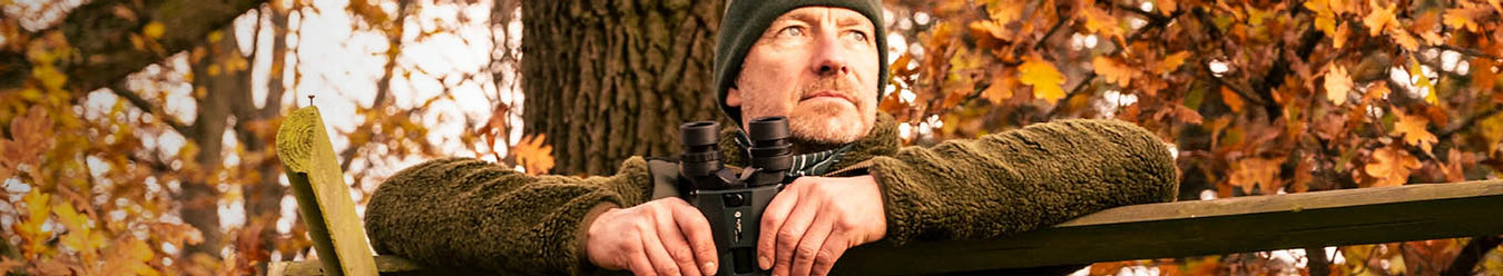 A man with a pair of alpen optics hunting binoculars
