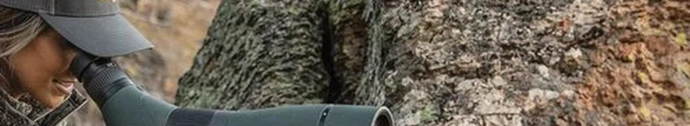 A photo of a lady using a vortex hunting scope out in the bush.