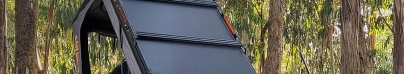 A photo of a san hima hard shell roof top tent.