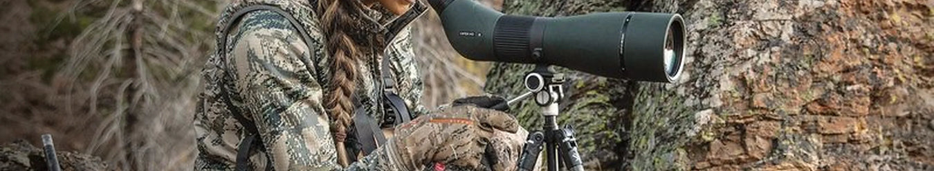 A lady using a vortex viper hunting scope whilst outdoors