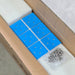 A photo of an amptron bluedge slimline 105ah 180a lithium battery's box with a pakcket of screws on top of it.