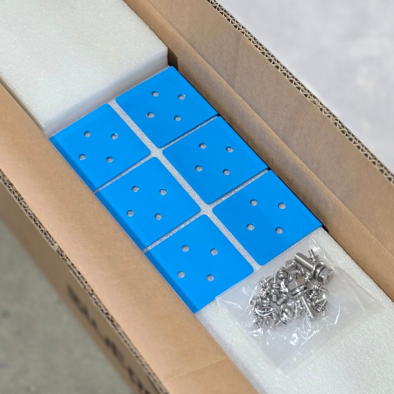 A photo of an amptron bluedge slimline 105ah 180a lithium battery's box with a pakcket of screws on top of it.