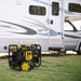 Champion 4.5 kW Open Frame Generator behind the Van on an outdoor set up