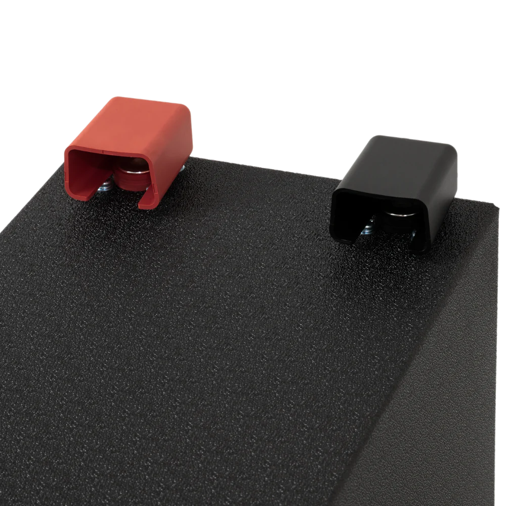 A photo showing the red and black terminals of a custom lithium 310ah compact lithium battery.