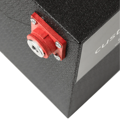 A photo of a black custom lithium 560ah 12v lithium battery showing the red terminal connection.