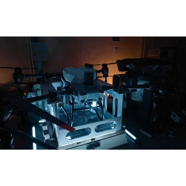 in the photo a DJI Agras T50 on a dark room
