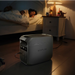 A photo of an EcoFlow Delta 3 plus portable power station sitting on a bedroom floor.