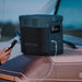 A photo of an EcoFlow Delta 2 Portable Power Station with a phone plugged into it.