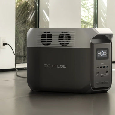 A photo of an EcoFlow Delta 3 1500w Portable power station on a slight angle charging with a standard AC connection.