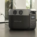 A photo of an EcoFlow Delta 3 1500w Portable power station on a slight angle charging with a standard AC connection.
