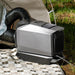 A photo of an EcoFlow WAVE 3 portable heater cooler sitting outdoors next to a tent on a mat.