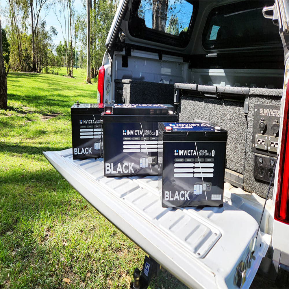 Invicta Black Lithium Battery on the back of a car outdoor setting