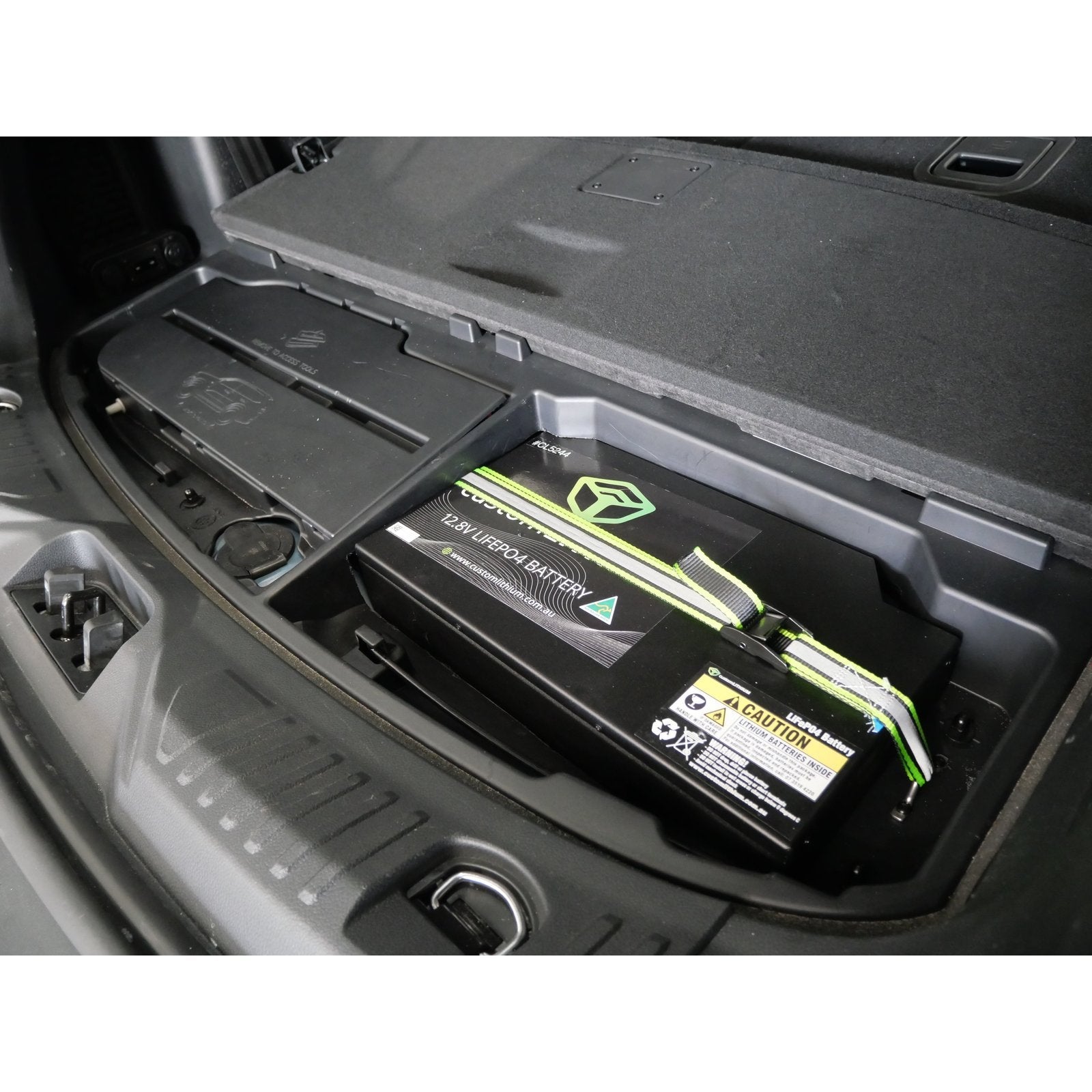 Custom Lithium dual battery installed in the wet area of a Next Gen Ford Everest with the jack and tool holder still in place.
