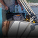 A photo of a man holding an iTechWorld 200ah deep cycle lithium battery inside of a boat.