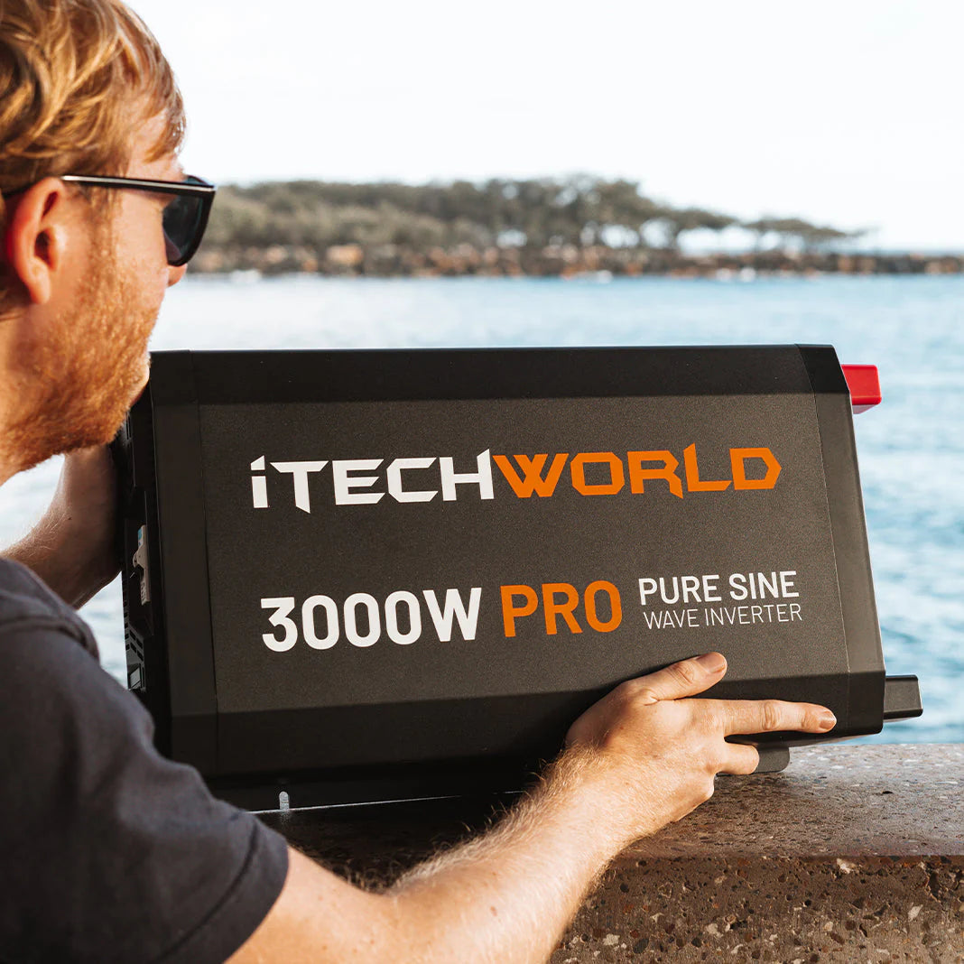 A photo of a man holding an iTechWorld 3000W Pro pure sine wave inverter