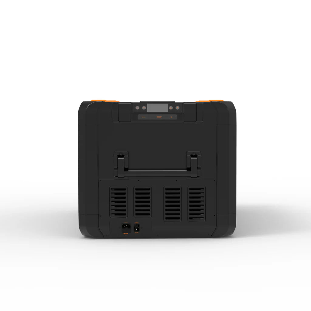 A photo of a black and orange iTechWorld iFrost 95L portable camping fridge/freezer facing side on showing power inputs and its handle.