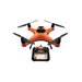 Top angled view of the orange SwellPro Fisherman FD1S fishing drone with carbon fibre propellers, beside its SwellPro remote controller with built-in screen.