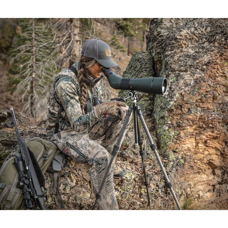 Hunter seated on a rocky hillside glassing with the Viper 20-60x85 Angled Scope on a tripod, tripod sold separately