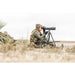 Hunter glassing open country with the Viper 20-60x85 Straight Scope on a tripod beside a rifle, tripod sold separately